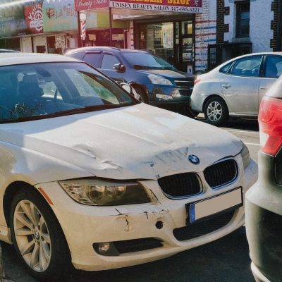 Damaged Front of A White Car